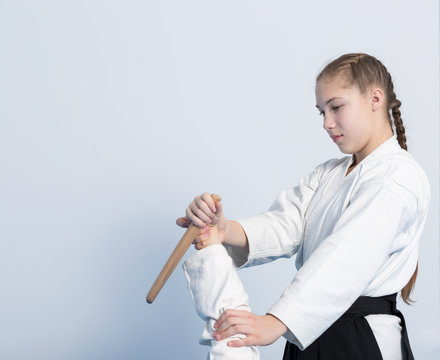 Two girls on Aikido training with a knife practice on white background