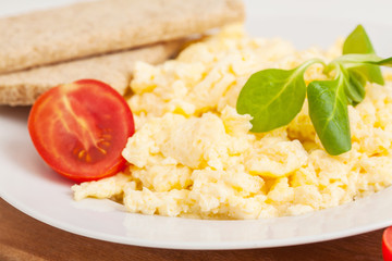 scrambled eggs with herbs and vegetables on the plate