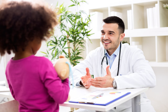 Pediatrician talking positively with kid