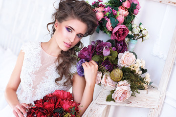 Young gorgeous bride with flowers.