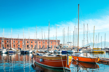 Fototapeta premium Street view of Naples harbor with boats