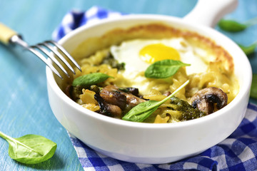 Pasta baked with spinach pesto,egg,mozzarella and mushrooms in a