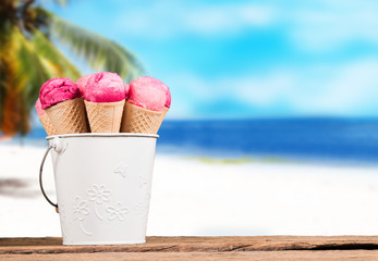 Frozen Ice-cream. Strawberry ice creams in cone with tropical beach background. Summer concept