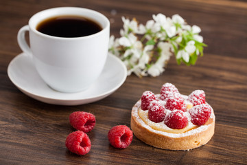 sweet cake with cup of tea on wooden table