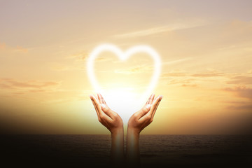 Human hands protect the heart Sky background