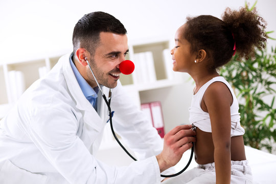 Funny pediatrician with little cute child