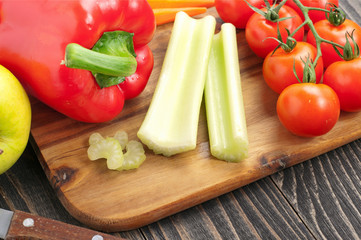 Celery sticks with red peppers, carrots, tomatoes and apples