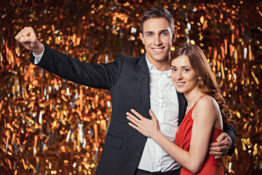 Beautiful couple on glitter gold background