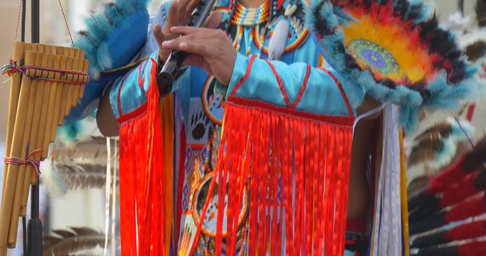 Costume Close Up Man Playing Flute and Dancing Indians Performers in National Costumes Feathers Ribbons Necklaces are Singing Playing National Music