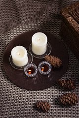 Candles and cones on a woolen plaid