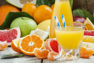 Healthy fresh citrus cocktail in the big glass with striped stra