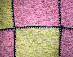 Pink and yellow hand knitted blanket