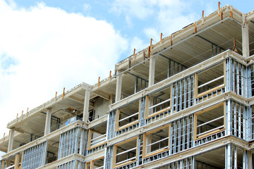 Contruction site of residential building on blue sky background