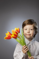 cheerful kid with a bouquet of tulips