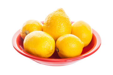 Whole lemon on a red plate isolated on white background
