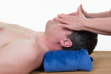 Fototapeta na wymiar Man is getting a face massage at spa center
