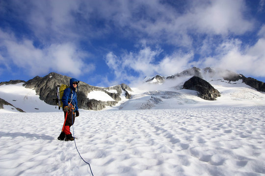 Mountaineer climbing up the Wedgemount Glacier in Garibaldi Park, British Columbia, Canada.