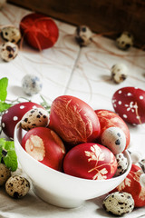 Painted brown Easter egg with a pattern, quail eggs, twigs of wi