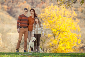 Naklejka na ściany i meble Family are walking on the autumn nature