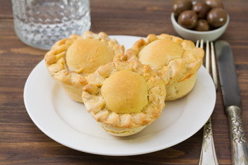 cake with chicken on white plate on brown wooden background