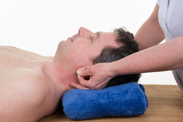 Fototapeta na wymiar Mature male receiving ear reflexology massage of both ears at the same time.