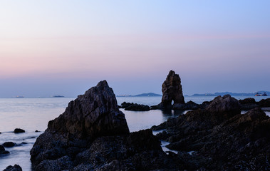 The sea with rocks after sunset