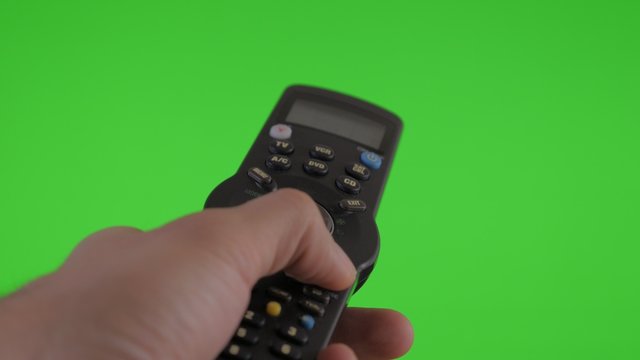Changing channels with remote control in hand on green screen chroma background 4K 2160p UHD footage - Remote control gestures on greenscreen background 4K 3840X2160 UHD video 