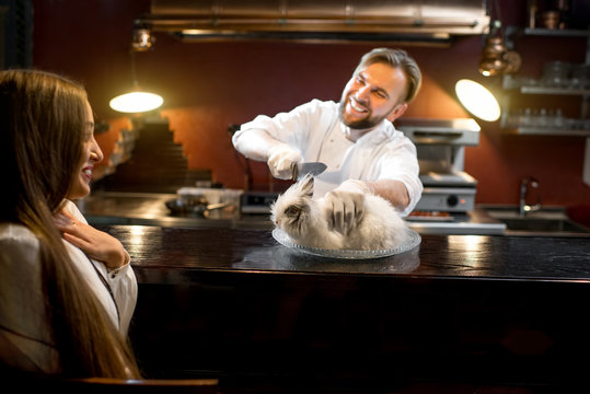 Crazy chef cook cutting alive rabbit