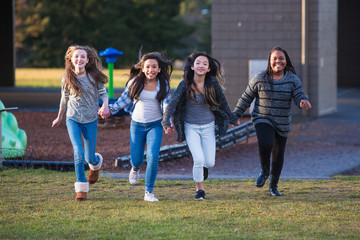 Group of happy kids running outside