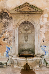 Fototapeta na wymiar Interior of the vandalized Casa da Agua (Water House), an 18th century fountain and reservoir built for the pilgrims of the Nossa Senhora do Cabo Sanctuary. Espichel Cape, Sesimbra, Portugal.
