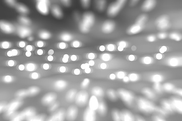 Bokeh light, shimmering blur spot lights on silver abstract 