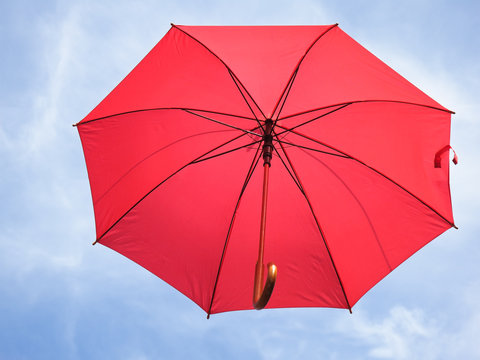 red umbrella on a background of blue sky