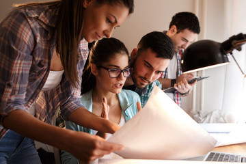 A dedicated group of students comes together at home to tackle their homework assignments, supporting each other in their shared quest for knowledge. - obrazy, fototapety, plakaty