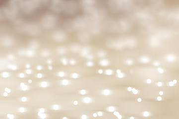 Bokeh light, shimmering blur spot lights on beige abstract