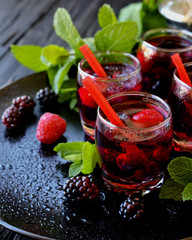 berry juice in a glass with berries, selective focus