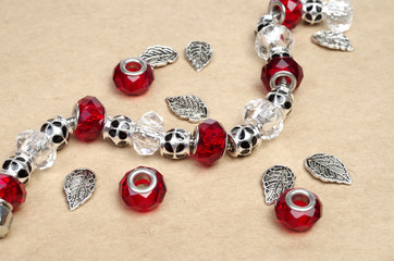 Modern fashion jewellery with charms and pendants on craft background