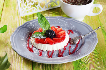 cake panna cotta, cheese strawberries and mint on a gray plate Provence still life dessert