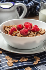 Bowl of cereals with raspberrie.