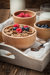 Bowl of cereals with blueberries and raspberrie.