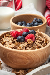 Bowl of cereals with blueberries and raspberrie.