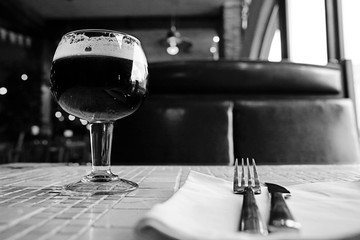 glass of dark beer in a pub