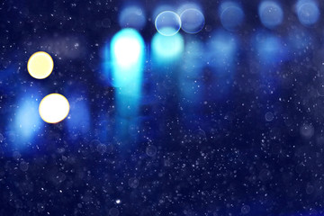 Fototapeta na wymiar blurred background snow snowfall night lights glass