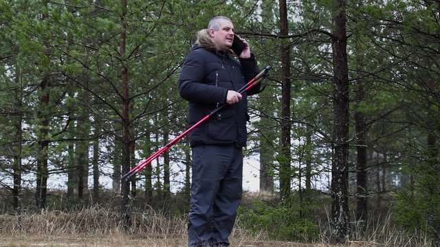 Hiker using smartphone in forest