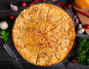 Hot cheese pizza on old wooden table