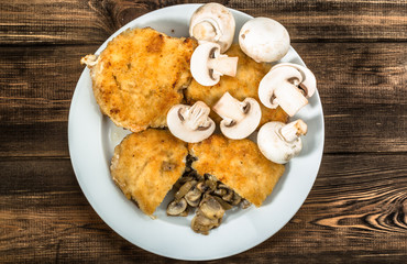 Fried chicken kiev from chicken breast stuffed with champignons.