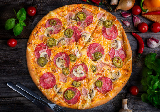 Pepperoni pizza with ham and jalapeno chili peppers