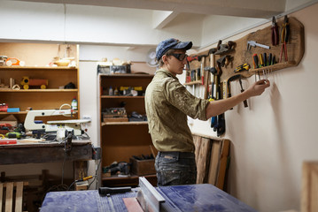 for the production of wood products shop worker takes the right tool