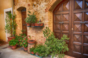 View of the ancient old european city. Street of Pienza, Italy with wooden doors.