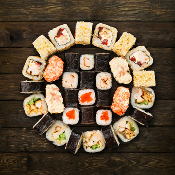 Set of sushi, maki and rolls isolated at wood
