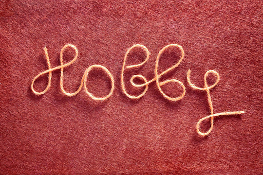 The Inscription Handmade Made of  Yarn on the Red Felt Fabric Ba